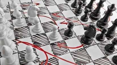Chess. White board with chess figures on it. Plan of battle.